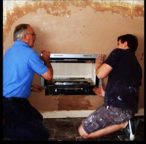 John Hanlon and our founder fitting a gas fire together