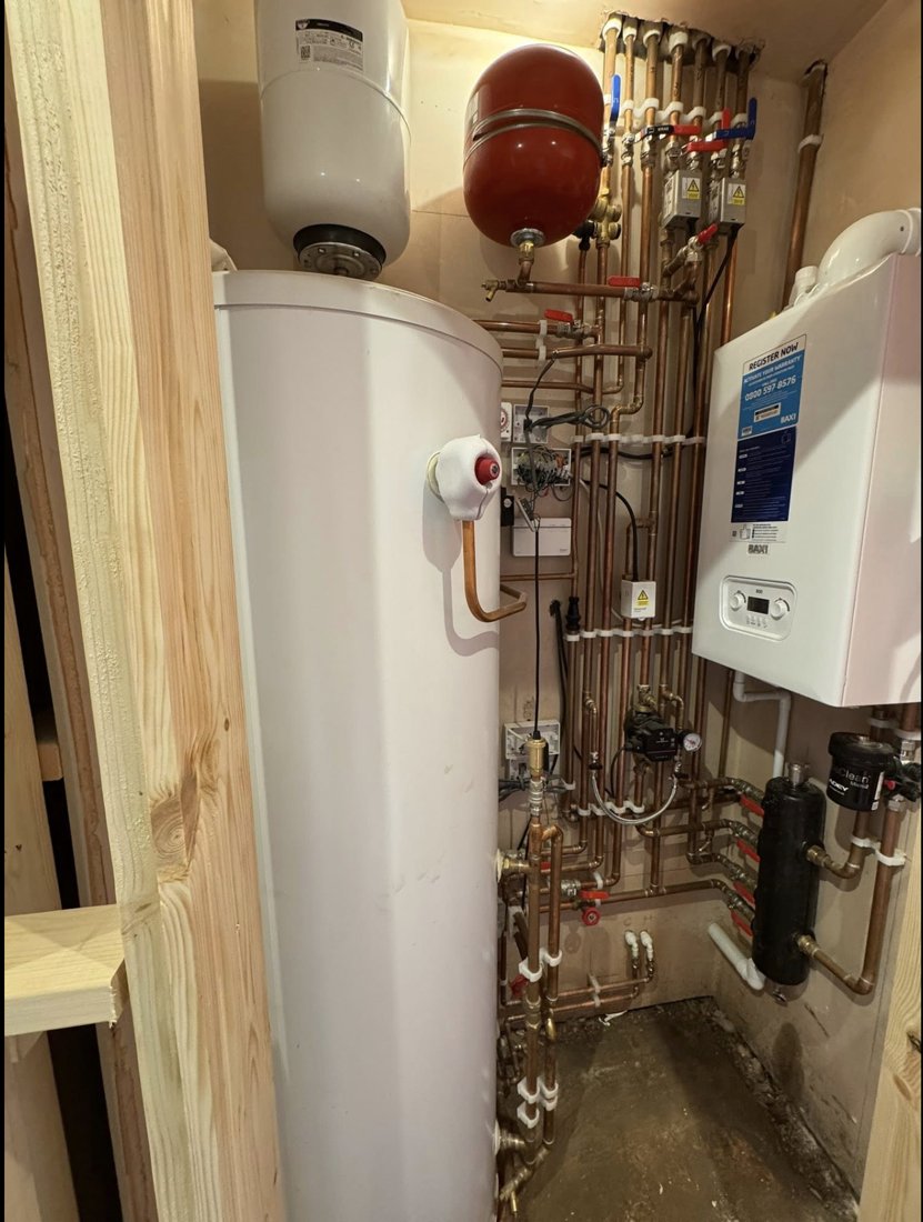 A plant room with a Baxi boiler, unvented cylinder and neat copper pipework